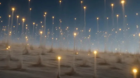 A vast gray dust plain at dawn with hundreds of points of golden light rising out of it
